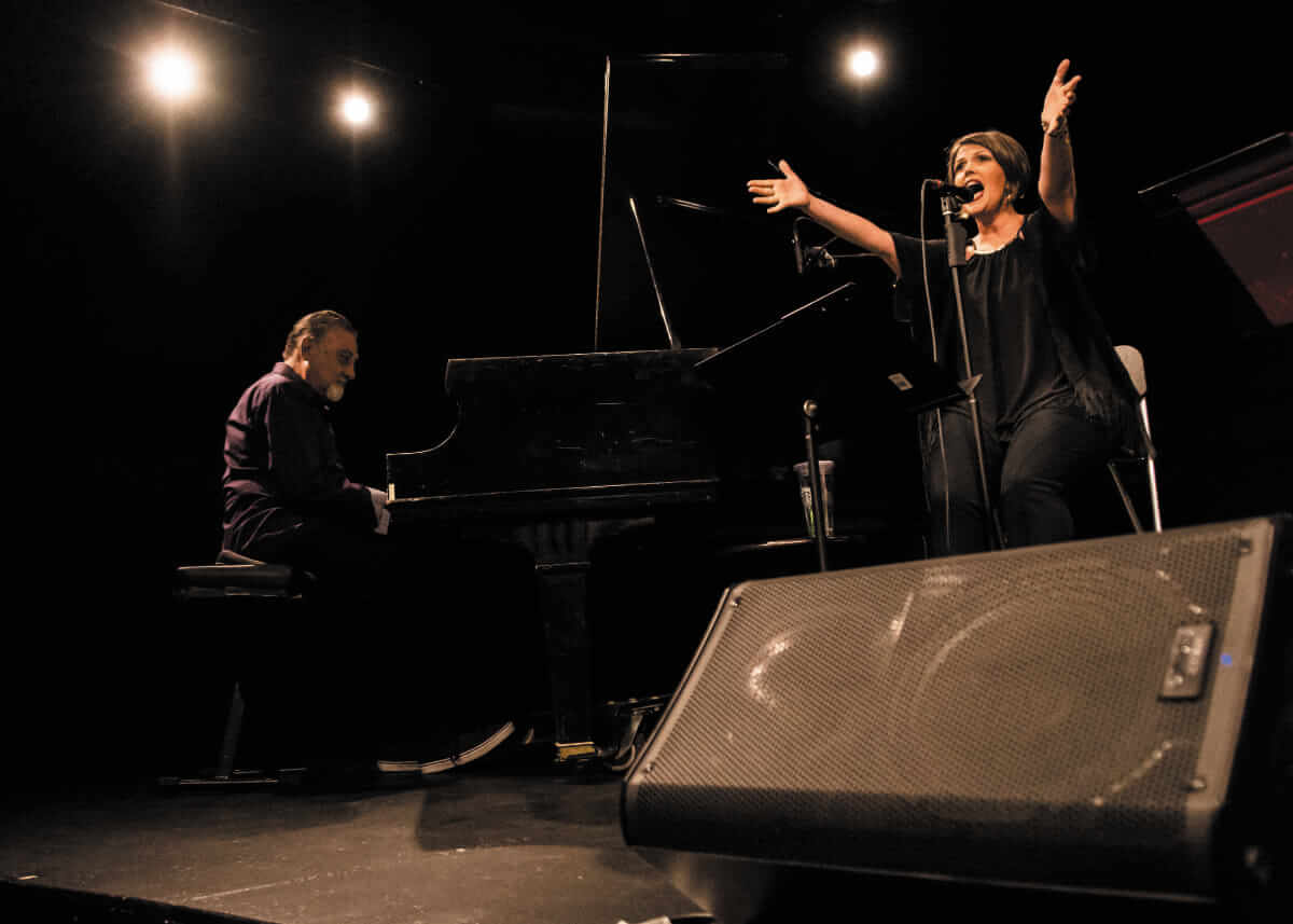 Michelle on stage open arms