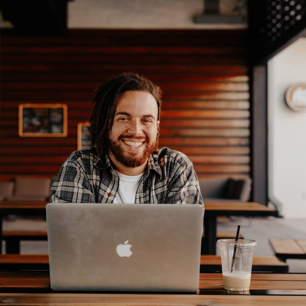 man with laptop smiling H2RA September 2022 (Commit